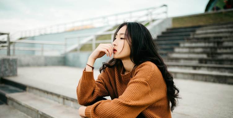 A person sitting on steps with her hand on her chin

AI-generated content may be incorrect.